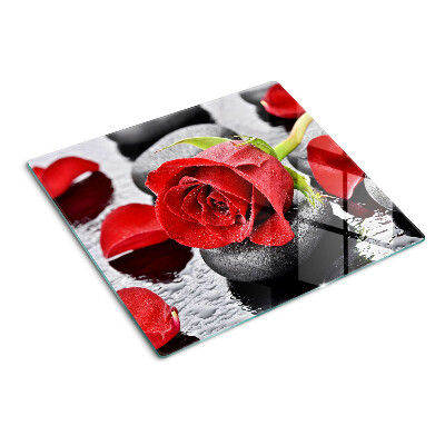 Planche à découper en verre Rose sur pierres avec gouttes d'eau