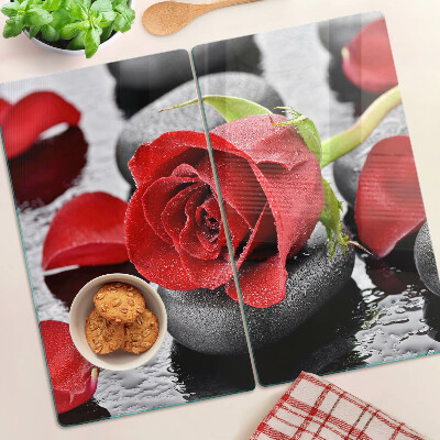Planche à découper en verre Rose sur pierres avec gouttes d'eau