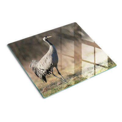 Planche à découper en verre Une grue sur fond de paysage