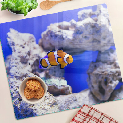 Planche à découper verre Poisson-clown parmi les rochers