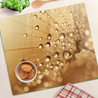 Planche à découper en verre Gouttes d'eau sur un pissenlit