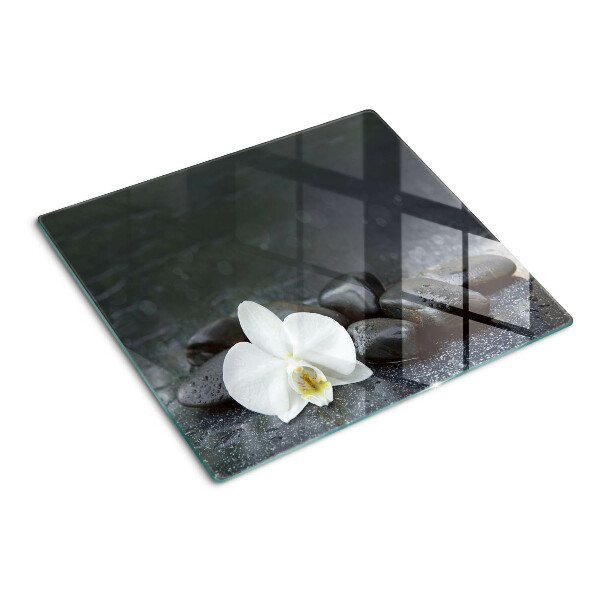 Planche à découper en verre Fleur d'orchidée sur pierres