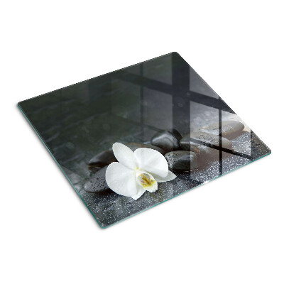 Planche à découper en verre Fleur d'orchidée sur pierres