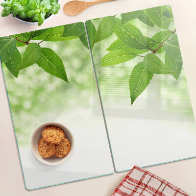 Planche à découper verre Feuilles sur fond vert flou