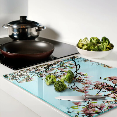 Planche à découper en verre Fleurs de magnolia sur fond bleu