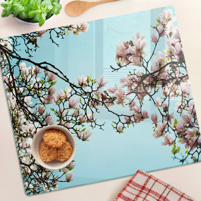 Planche à découper en verre Fleurs de magnolia sur fond bleu
