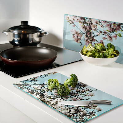 Planche à découper en verre Fleurs de magnolia sur fond bleu