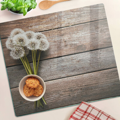 Planche à découper en verre Fleurs de pissenlit sur fond de bois