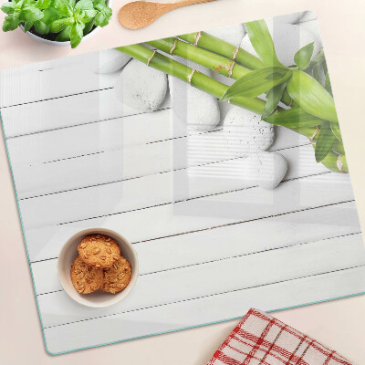 Planche à découper en verre Bambou et pierres sur fond de bois