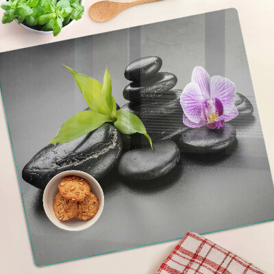 Planche à découper en verre Pierres et orchidées en arrière-plan