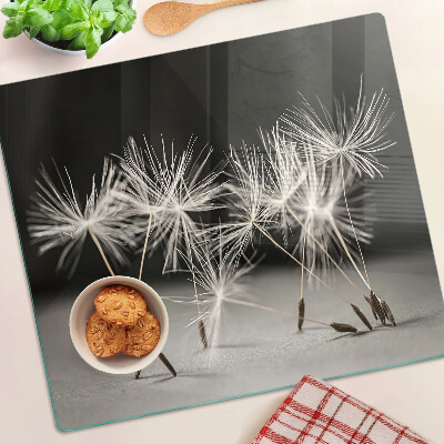 Planche à découper en verre Pissenlits duveteux sur un fond monochrome