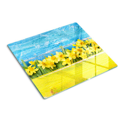 Planche à découper en verre Fleurs de jonquilles contre le ciel