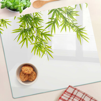 Planche à découper verre Feuilles de bambou sur le fond de la fenêtre