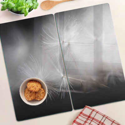 Planche à découper en verre Pissenlits duveteux sur fond de fenêtre
