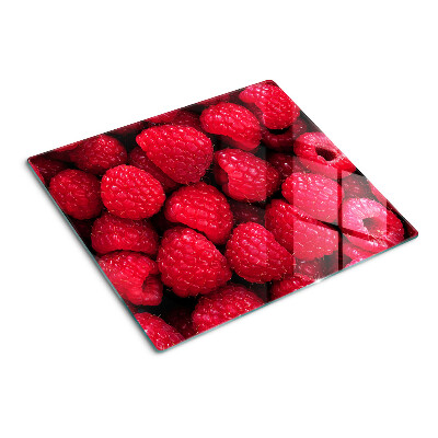 Planche à découper verre Des framboises en arrière-plan