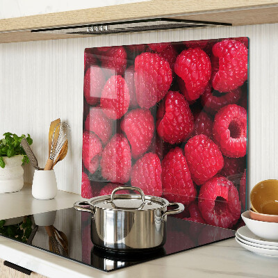 Planche à découper verre Des framboises en arrière-plan
