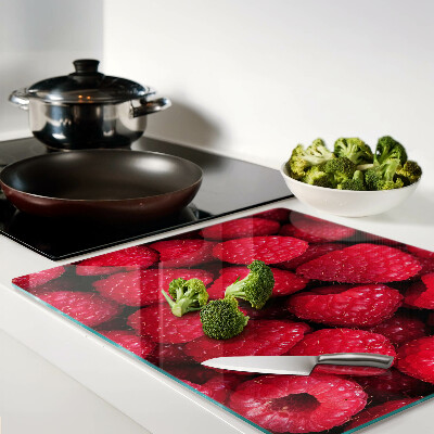 Planche à découper verre Des framboises en arrière-plan