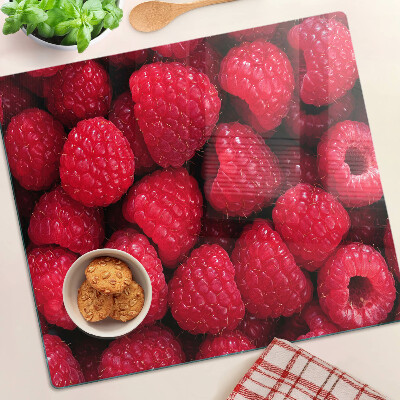 Planche à découper verre Des framboises en arrière-plan