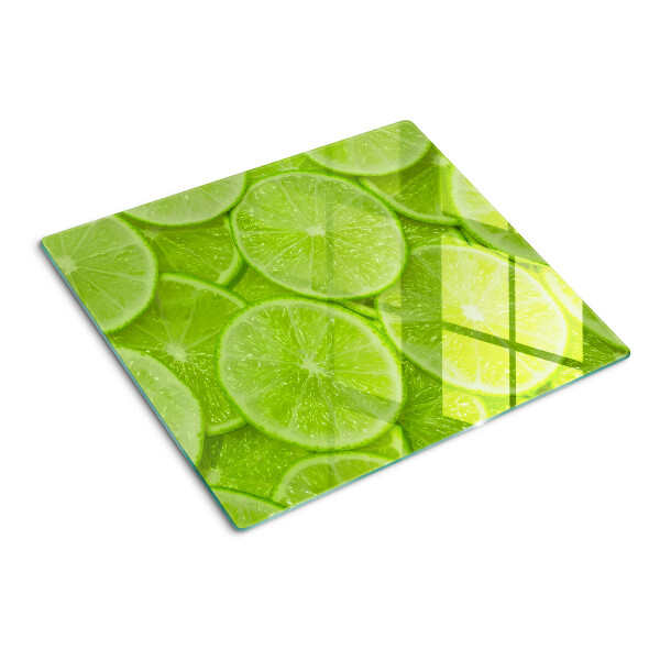 Planche à découper verre Tranches de citron vert sur fond vert