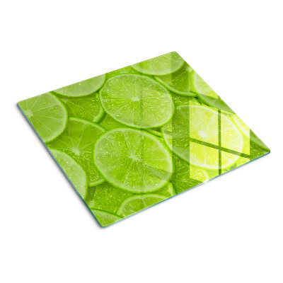 Planche à découper verre Tranches de citron vert sur fond vert
