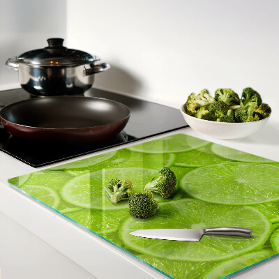 Planche à découper verre Tranches de citron vert sur fond vert