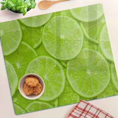 Planche à découper verre Tranches de citron vert sur fond vert