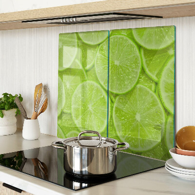 Planche à découper verre Tranches de citron vert sur fond vert