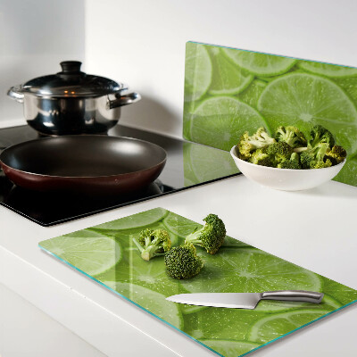 Planche à découper verre Tranches de citron vert sur fond vert