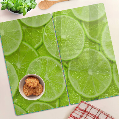 Planche à découper verre Tranches de citron vert sur fond vert