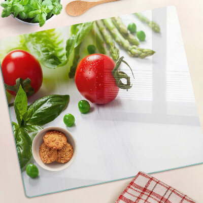 Planche à découper verre Légumes sur un comptoir blanc