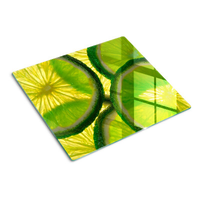 Planche à découper en verre Tranches de citron vert sur fond vert
