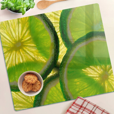 Planche à découper en verre Tranches de citron vert sur fond vert