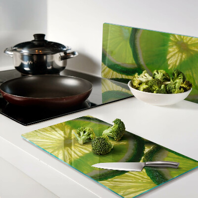 Planche à découper en verre Tranches de citron vert sur fond vert