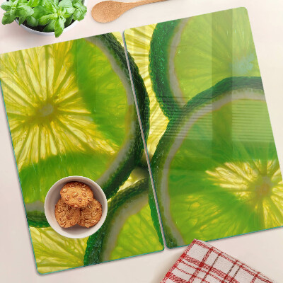 Planche à découper en verre Tranches de citron vert sur fond vert