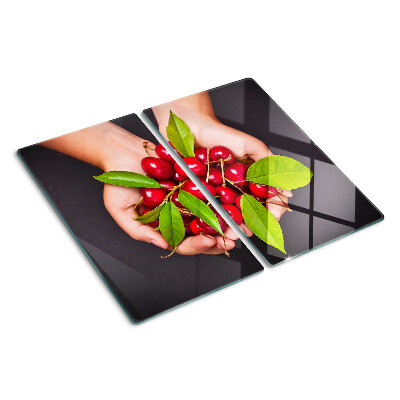 Planche à découper verre Cerises rouges dans les mains