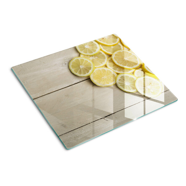 Planche à découper verre Tranches de citron sur fond de bois