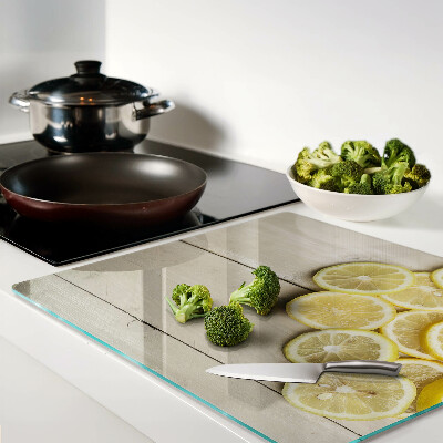 Planche à découper verre Tranches de citron sur fond de bois
