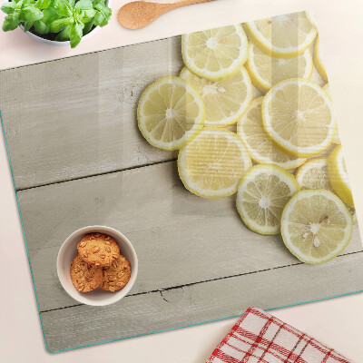 Planche à découper verre Tranches de citron sur fond de bois