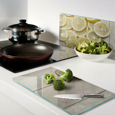 Planche à découper verre Tranches de citron sur fond de bois