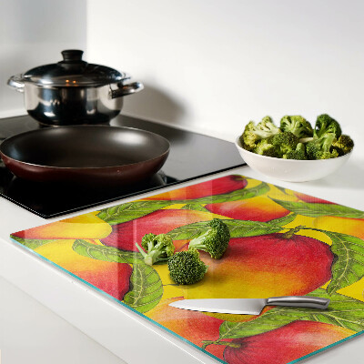 Planche à découper verre Poivrons sur fond de feuilles vertes