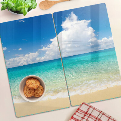 Planche à découper verre Plage avec eau turquoise et nuages