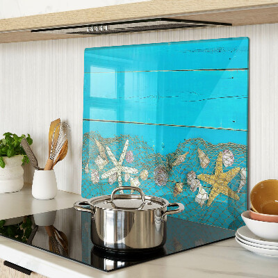 Planche à découper verre Coquillages et étoiles de mer dans un filet