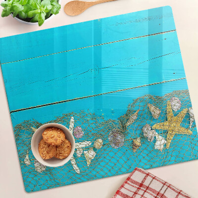 Planche à découper verre Coquillages et étoiles de mer dans un filet