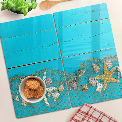 Planche à découper verre Coquillages et étoiles de mer dans un filet