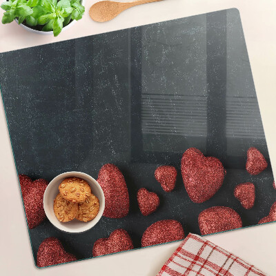 Planche à découper en verre Coeurs rouges sur fond sombre