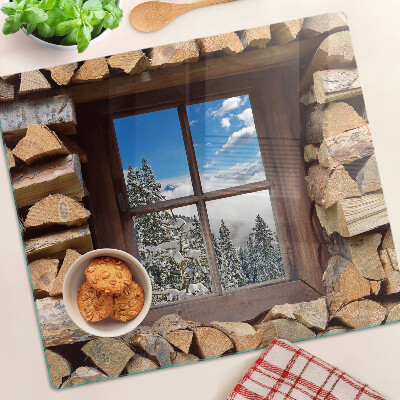 Planche à découper verre Vue d'un paysage d'hiver à travers la fenêtre