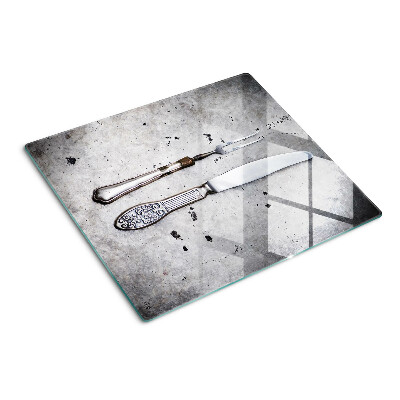 Planche à découper en verre Couverts sur fond de béton