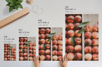 Impression sur toile Pêches avec leurs feuilles dans une boîte en bois