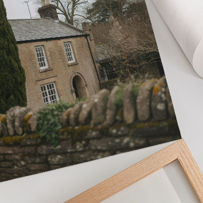 Affiche décorative Une maison chaleureuse, des arbres, un muret en pierre, une atmosphère paisible