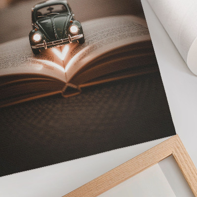 Impression sur toile Voiture miniature sur un livre avec des lumières magiques